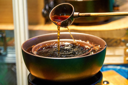 Traditional Chinese copper pot is cooking Pu'er tea, making tea around the stoveの写真素材