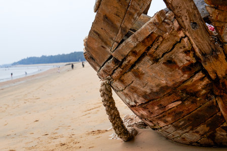 Close-up of abandoned wooden boat on the beach by the seaの写真素材