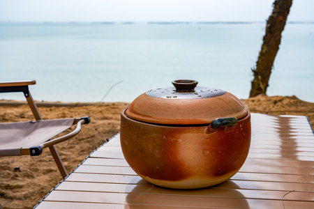 A pot of delicious seafood and shrimp porridge for camping on the beachの写真素材