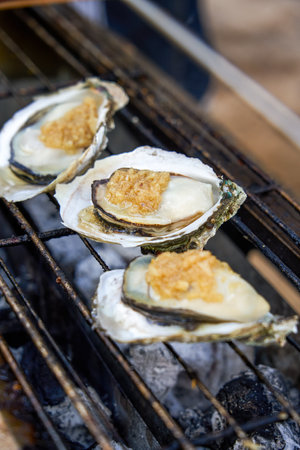 Sweet and delicious charcoal-grilled garlic oystersの写真素材