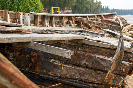 Close-up of abandoned wooden boat on the beach by the sea