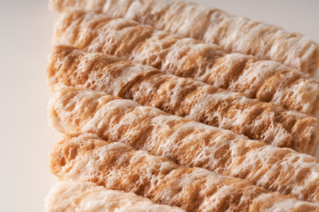 Crispy and delicious coconut crispy egg roll snack close up on white backgroundの写真素材