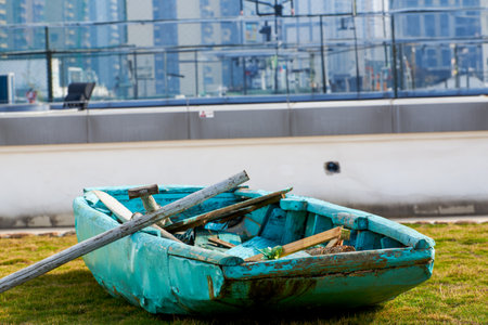 An abandoned wooden boat lying on the grassの写真素材