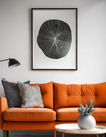 Interior of modern living room with orange sofa, pillows and posterの素材
