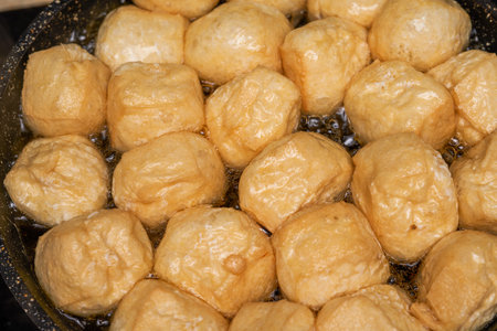 A chef is frying food in a pan in the kitchen
