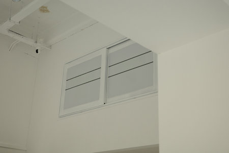 Pure white studio ceiling, wall and window close-up
