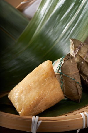 Close-up of triangular rice dumplings on background of traditional Chinese Dragon Boat Festival propsの写真素材