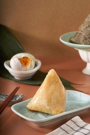 Close-up of triangular rice dumplings on background of traditional Chinese Dragon Boat Festival propsの写真素材