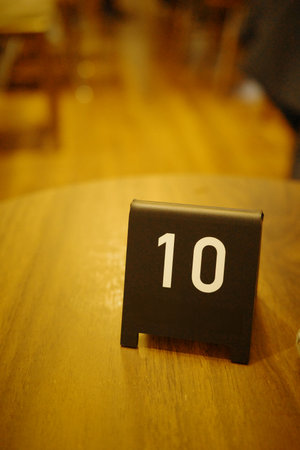Close-up of number 10 sign on wooden tableの写真素材