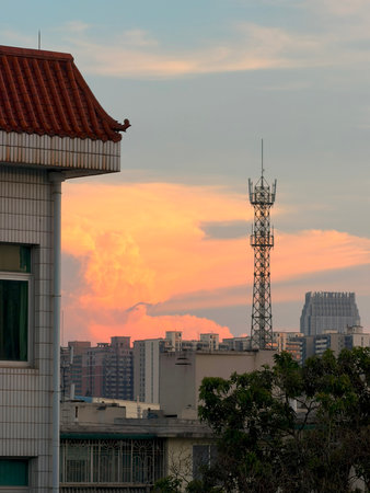 City buildings and television transmission towers at sunset