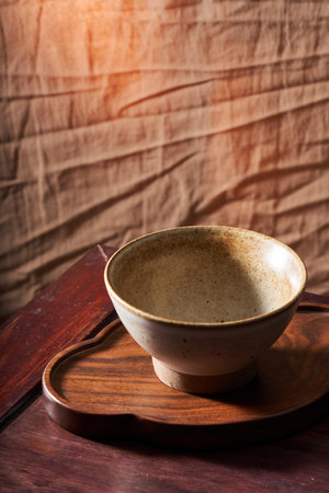An empty rice bowl tableware with a retro wooden backgroundの写真素材