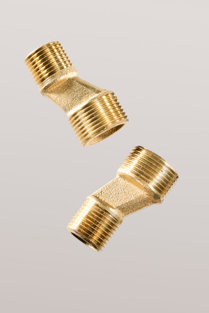 Image: Close-up of two brass water pipe connection castings