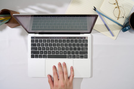 1 Business man typing on laptop keyboard in office