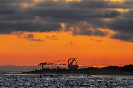 Sand Dredger clearing out sand banks at Upper Trestles beach, San Clemente, Southern Californiaの写真素材