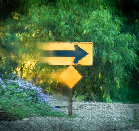 Blurred street sign against green backgroundの写真素材