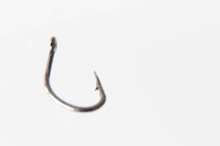 Shallow focus macro of single fish hook on white backgroundの写真素材