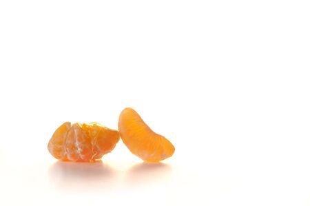 Four segments of peeled tangerine isolated on white backgroundの写真素材