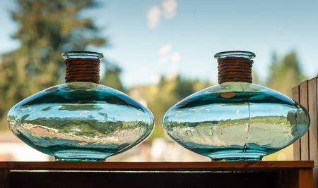 Two blue glass vases showing reflections of Oregon countrysideの写真素材