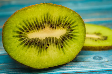 Juicy pieces of kiwi on a table, blue tableの写真素材