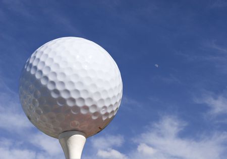 Golf ball with blue sky and moonの写真素材