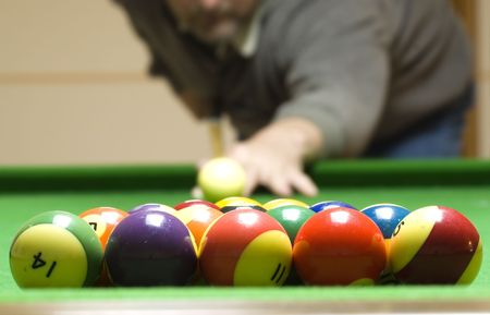 A man shooting a game of pool