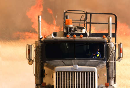Water truck fighting a large grass fireの写真素材