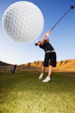 A golfer driving the ball down the fairway focus on the ballの写真素材