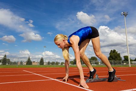 Young athlete on the starting blocks ready to raceの写真素材