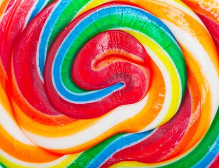 Closeup of a colorful spiral lollipop backgroundの写真素材