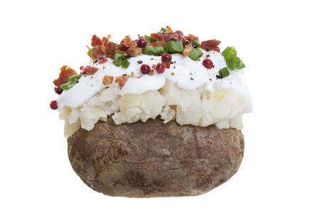 A stuffed baked potato with sour cream, bacon bits, and Green onions.
Shot on a white の写真素材