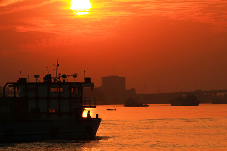 Busy water traffic over the sunset viewの写真素材