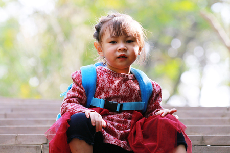 Cute little girl looking at the camera smilingの写真素材