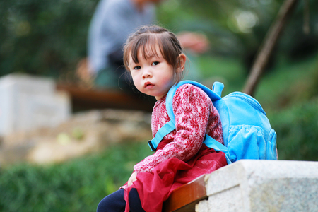 Tired little girl looking at the cameraの写真素材