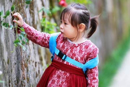 Cute little girl playing alone in the parkの写真素材