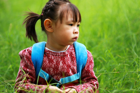 Looking back at the little girl in the distanceの写真素材