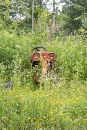 happy tractor abandoned in the fieldの写真素材