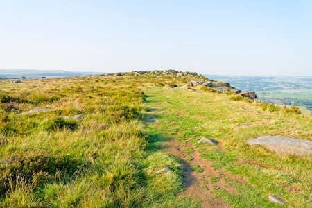Morning summer sun begins to warm up Baslow Edge in the Derbyshire Peak Districtの写真素材