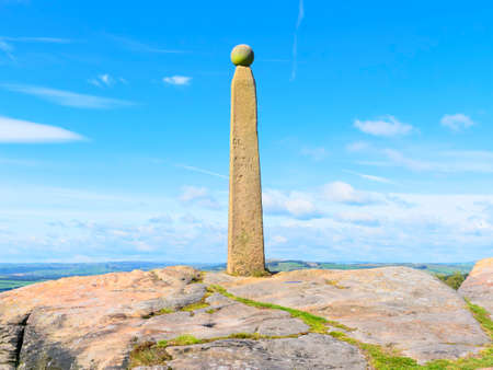 High on Birchen Edge, perched on a gritstone outcrop, stands a weathered 200 year old monument to...