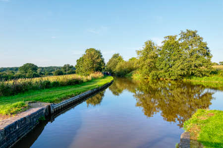 Late afternoon sunlight lights up the peaceful Shropshire Union Canal near Whitchurch