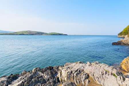 Looking out across the clear blue rippled water of the River Dwyryd estuary on a bright blue sky...
