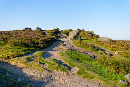 Footpath up the steep slopes of Higger Tor, winding between gritstone rocksの写真素材