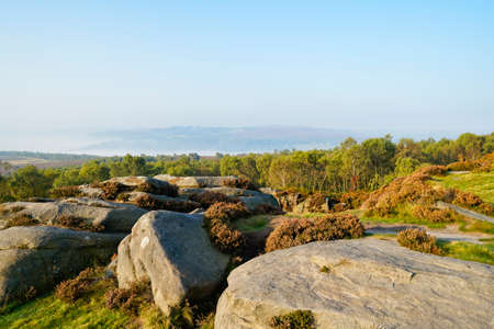 From the rock strewn slopes of Surprise View, across tree tops to a Derbyshire landscape emerging...