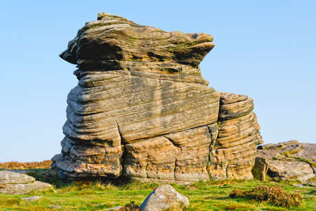 Mother Cap gritstone rock formation glows in the autumn sunlightの写真素材