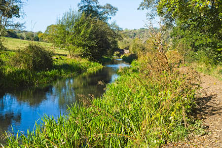 Cold, bright autumn morning beside the partially overgrown Cromford canal in Derbyshire.の写真素材