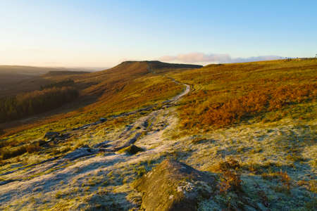 Frosty footpath extends across the slopes of Burbage Valley towards Higger Tor in the Derbyshire...