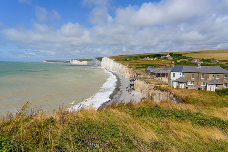 A blustery July morning on the clifftops of Birling Gap looking out towards the Seven Sisters chalk cliffs.の写真素材
