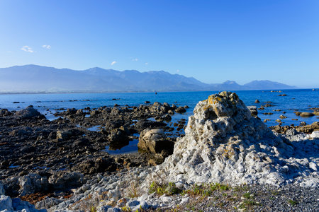 Hazy summer evening on Kaikoura beach at low tide.の写真素材