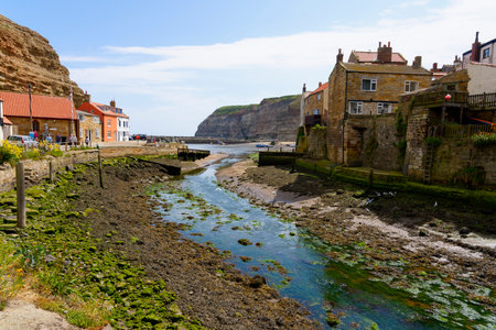 Tourists wander along the quayside in the Yorkshire village enjoying the spring sunshine.の写真素材