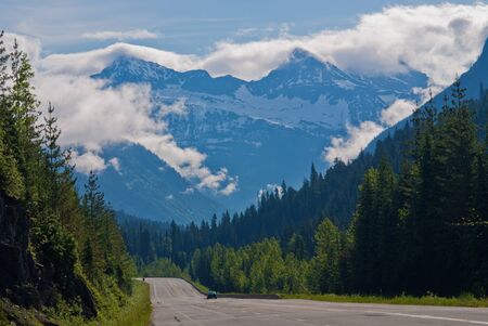 cloud enshrouded mountains, and the trans canada highway, revelstoke national park, british columbia, canada.の写真素材