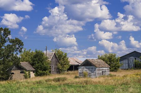 an old abandoned farm slowly decays from the dramatic changing weather of rural central minnesota.の写真素材